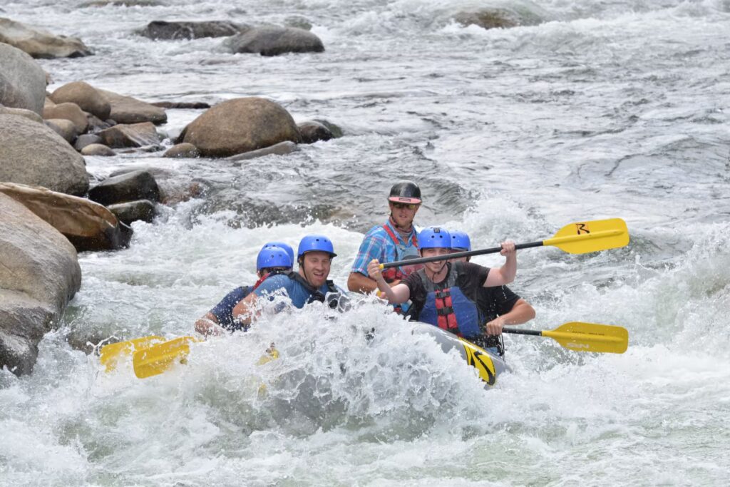 Group paddling through a scenic stretch of the Arkansas River during the Happy Hour Float Trip